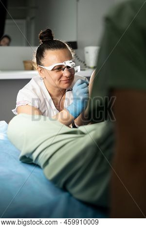 Dermatologist Doing Hair Removal Treatment On Patients Leg With Electrolysis, Doing Electroepilation