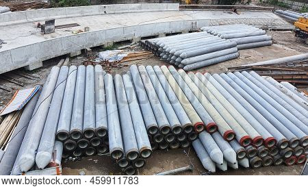Pile Of Precast Concrete Spun Pile In A Construction Project Stockyard.