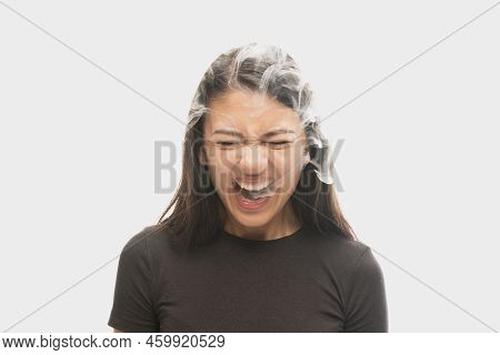 Shouting Young Girl With Dark Hair Releases Smoke From The Mouth Isolated Over White Background. Con