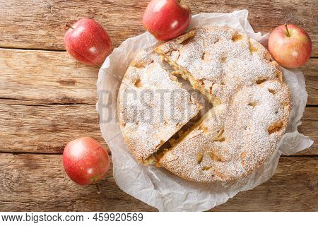 Sliced Apple Pie Sharlotka And Red Apples On A Wooden Table. Horizontal Top View From Above