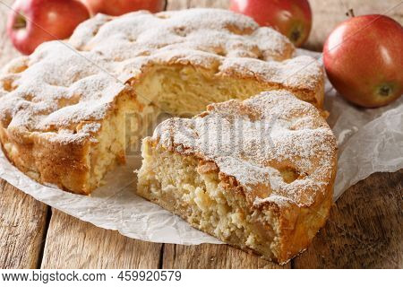 Sliced Apple Pie Sharlotka And Red Apples On A Wooden Table. Horizontal