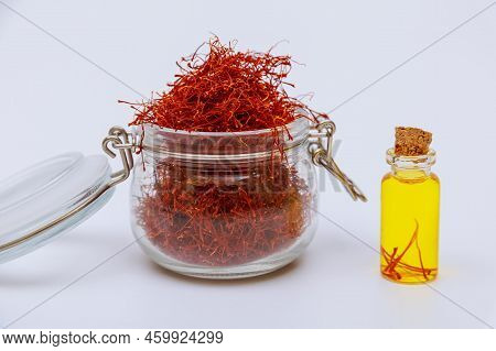 Pile Of Stamens In A Glass Jar And Saffron Tea In A Small Jar.