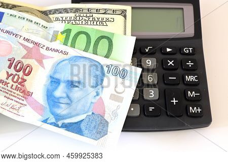 Dollar, Eruo And Turkish Lira With A Calculator And A Pen