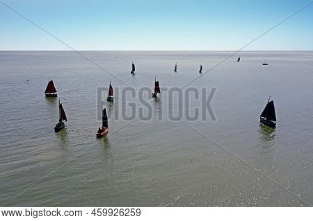 Aerial From Traditional Dutch Wooden Boats At The Ijsselmeer Near The Harbor From Laaxum In Frieslan