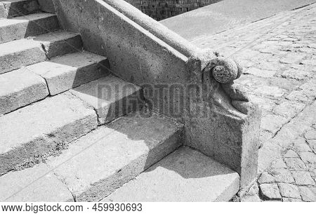 Part Of An Old Stone Staircase With An Elegant Railing End Cap In The Form Of A Quatrefoil Carved In