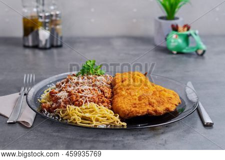 Milanese Spaghetti With Fried Ribs On A Gray Table