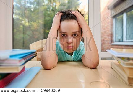 Portrait Of Caucasian Stunning Smart Boy, Elementary School Student Holding His Head And Looking At 