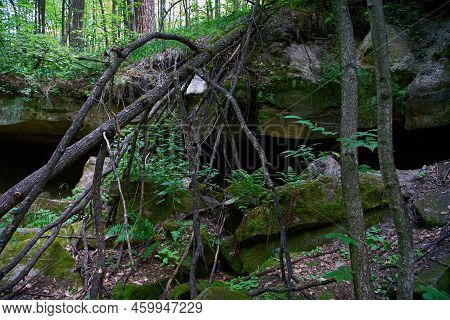 A Small Grotto, A Gorge In The Forest. Natural Background.