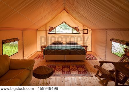 Glamping Inside The Tent. The Interior Of A Large Glamping Tent. Glamping Tent In The Forest. Luxury
