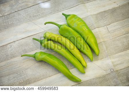 Raw, Green And Fresh Juicy Hot Peppers On A Gray Table.