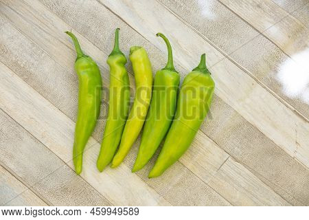 Raw, Green And Fresh Juicy Hot Peppers On A Gray Table.
