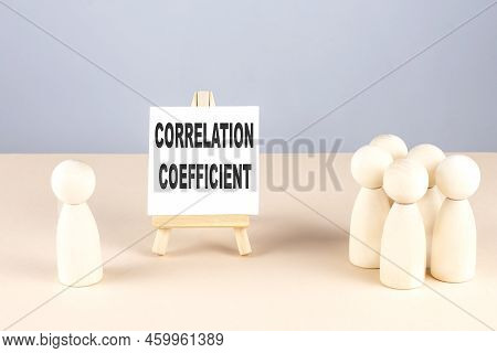 Correlation Coefficient Text On Easel With Wooden Figure, Meeting Concept