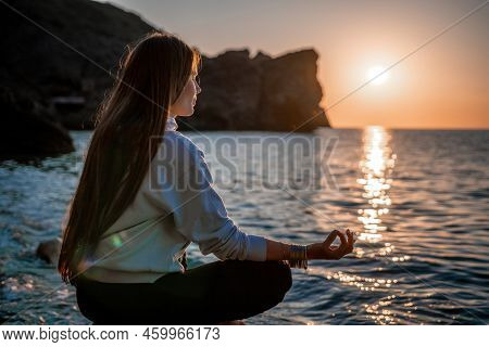 Young Woman With Long Hair In Sportswear And Boho Style Braclets Practicing Outdoors On Yoga Mat By 