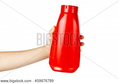 A Bottle Of Ketchup In A Childs Hand. Holds A Red Plastic Bottle. Holds A Bottle Of Catsup. Catsup B