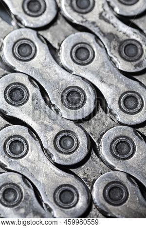 Closeup View Of Shiny Dirty Greasy Oiled Bicycle Chain As A Part Of Metal Bicycle Equipment On Grey