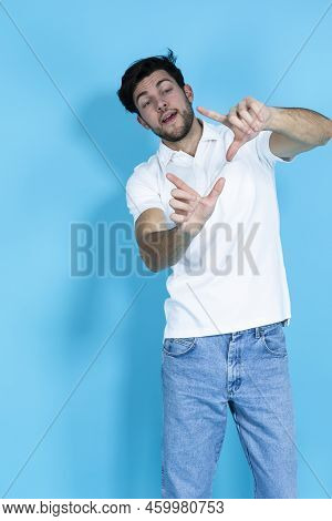 One Handsome Brunet Man In White Shirt And Hipster Red Glasses While Holding Imaginable Framing Film