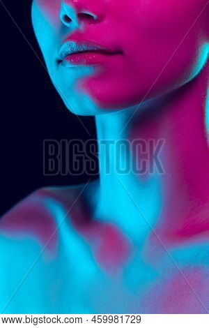Closeup Female Lips, Cheeks And Nose Isolated Over Dark Background In Neon Light. Concept Of Cosmeto
