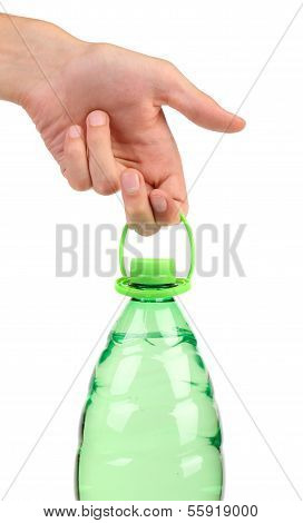 Hand holds plastic bottle.