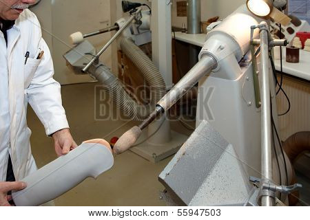 A Worker At A Tunnel Grinding Machine.