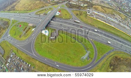 Cars ride by bridge of Abramtsevskaya overpass on Moscow beltway at autumn day. View from unmanned quadrocopter