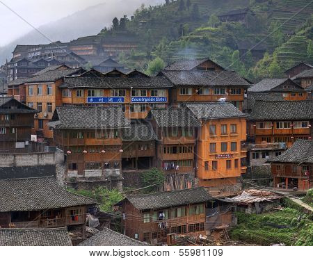 Wooden Building Rural Hotels In Chinese Village Of Ethnic Minorities.