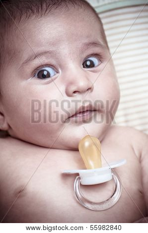 Pacifier, new born baby curled up sleeping on a blanket, multiple expressions