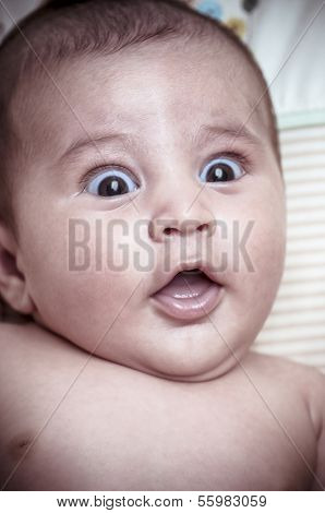 new born baby curled up sleeping on a blanket, multiple expressions