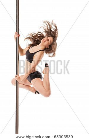 Young sexy woman exercise pole dance against white