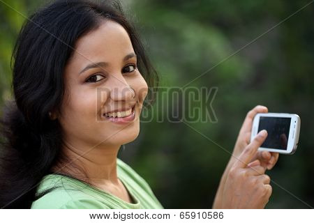 Happy Young Woman Text Messaging At Outdoors