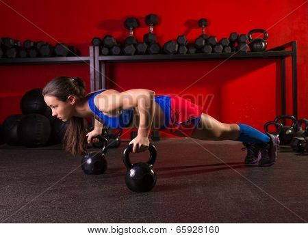 Kettlebells push-up woman strength pushup exercise workout at gym