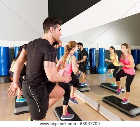 Cardio step dance people group at fitness gym training workout