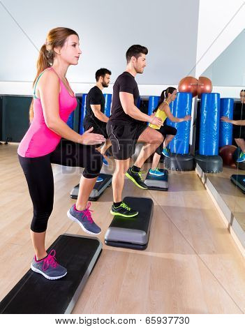 Cardio step dance people group at fitness gym training workout