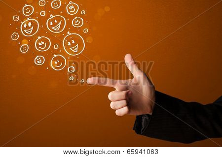 Group of happy hand drawed smiley faces coming out of gun shaped hands