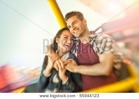 couple playing shooting games while visiting an amusement park, young man holding gun and shooting  - shoot with lensbaby