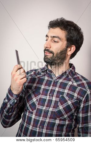 young man want comb his beard and moustaches