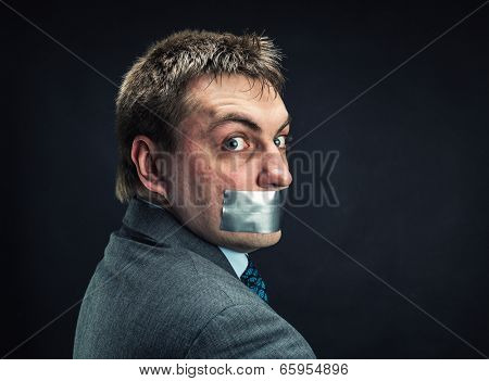 Man with mouth covered by masking tape