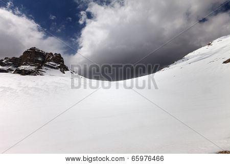 Snowy Mountain Pass And Sky With Storm Clouds