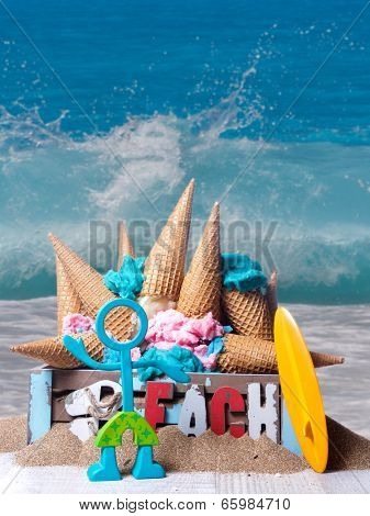 Icecreams cones mess in a box on the beach with sufr dude