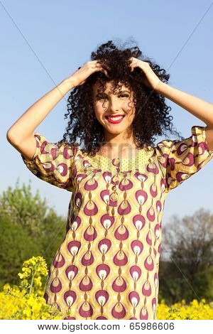 happy carefree young beautiful smiling girl walking in the field