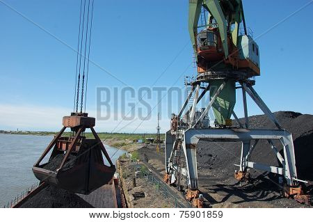 Crane Loading Coal To Ship At Kolyma River Port