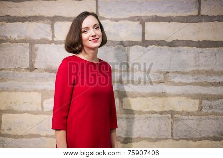 Woman In Hallway Next To Limestone Wall