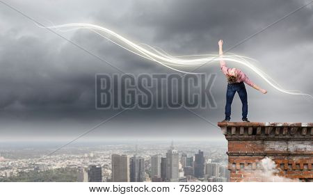 Young guy in casual evading from light rays