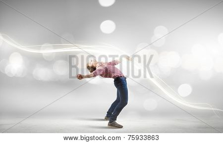 Young guy in casual evading from light rays