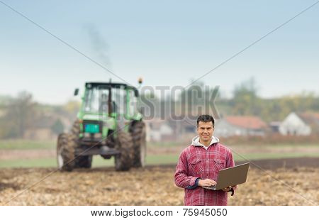 Man With Laptop In The Field
