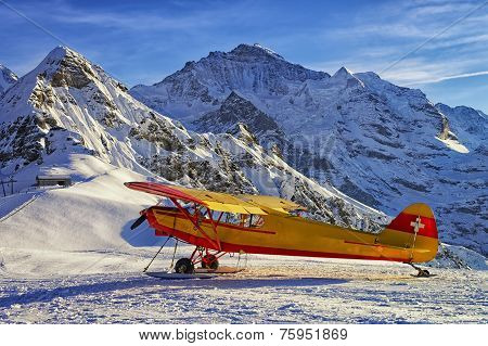 Yellow Red Airplane At The Mountain Airfield In Swiss Alps