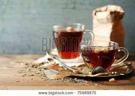 Beautiful vintage composition with herbal tea, on wooden table