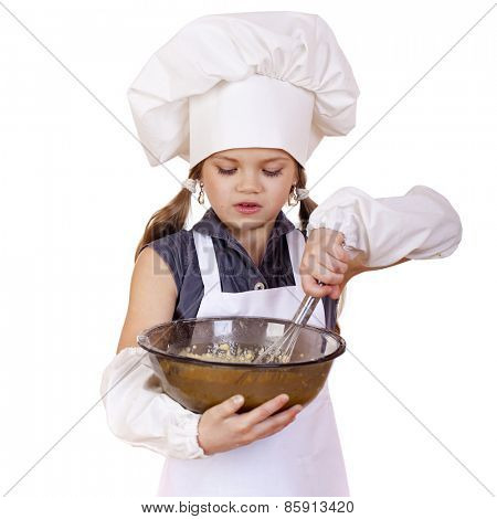 Little girl cook whips whisk eggs in a large plate, isolated on white background