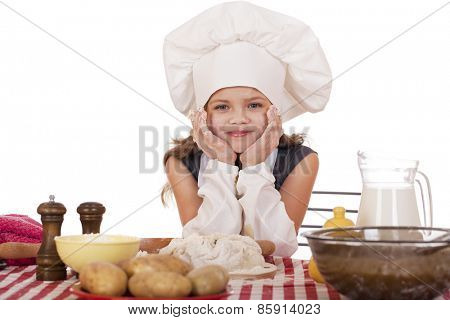 Beautiful little baby dressed as a cook, isolated on a white background