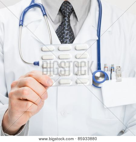 Doctor Holdling Pills In Hand - Studio Shot