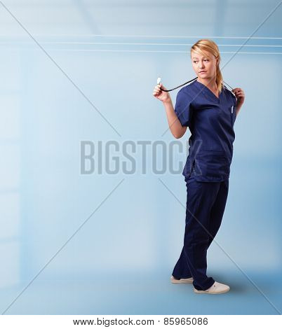 Pretty young nurse in hospital listening to empty copy space with sthetoscope